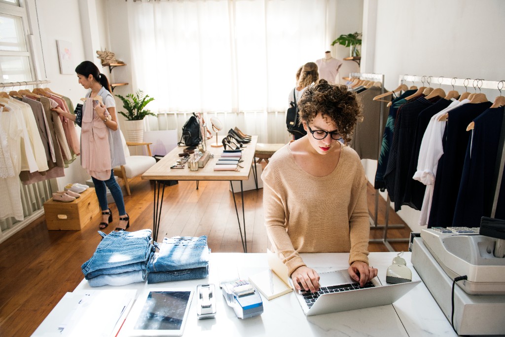 Retail business owner reviewing reconciliation results on her laptop